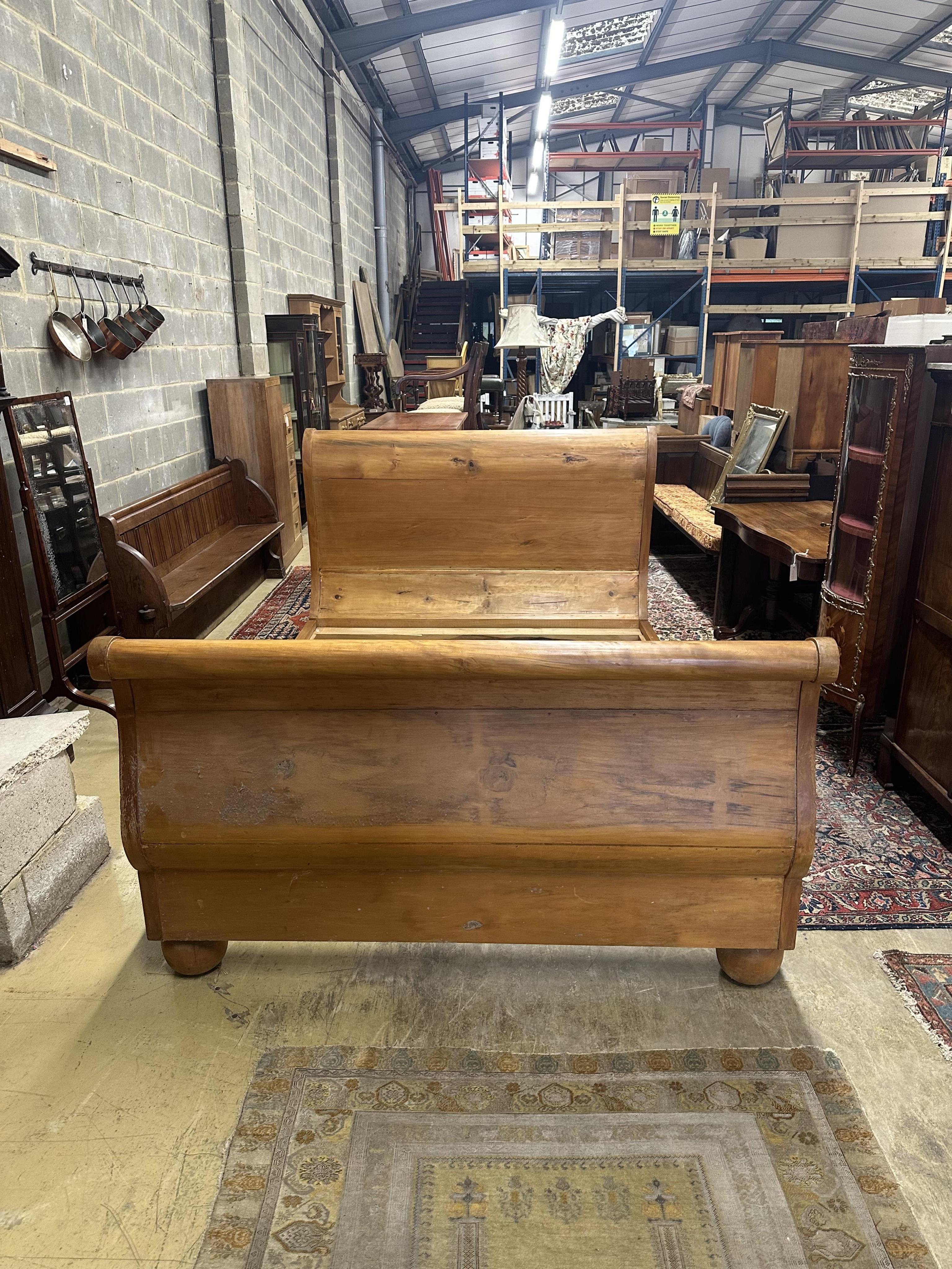 A Continental pine sleigh bed, width 164cm, length 250cm, height 120cm. Condition - poor-fair